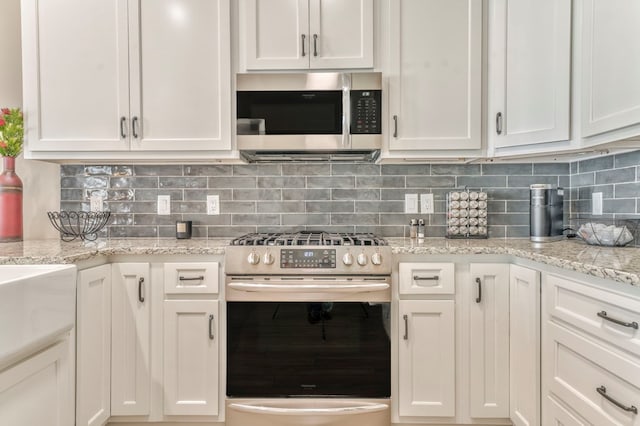 kitchen with white cabinetry, tasteful backsplash, and stainless steel appliances