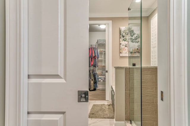 bathroom featuring walk in shower, vanity, and crown molding