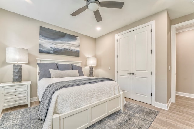 bedroom featuring a closet, ceiling fan, and light hardwood / wood-style flooring