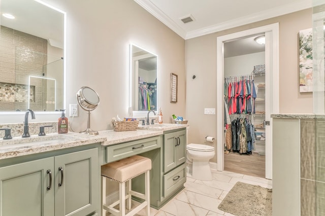 bathroom with vanity, a shower, ornamental molding, and toilet