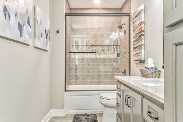 full bathroom with vanity, enclosed tub / shower combo, and toilet