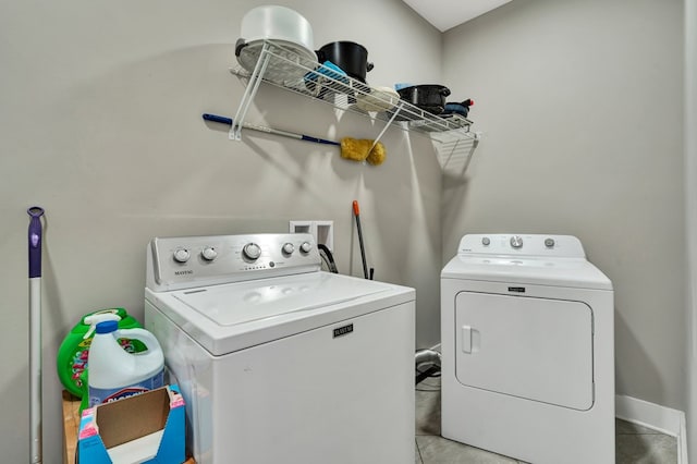 washroom with washing machine and clothes dryer