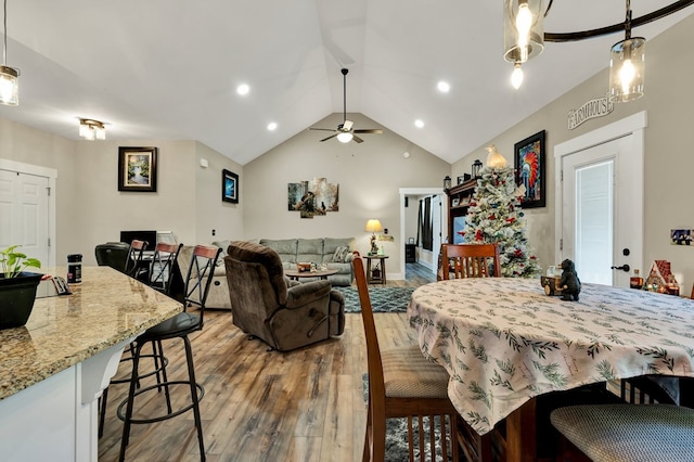 dining area featuring vaulted ceiling, dark hardwood / wood-style floors, and ceiling fan