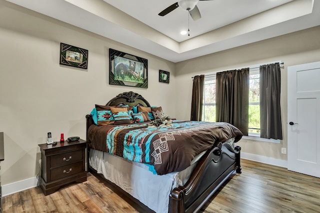 bedroom with light hardwood / wood-style floors and ceiling fan