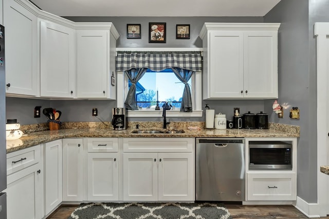 kitchen featuring sink, stainless steel appliances, white cabinets, and stone counters