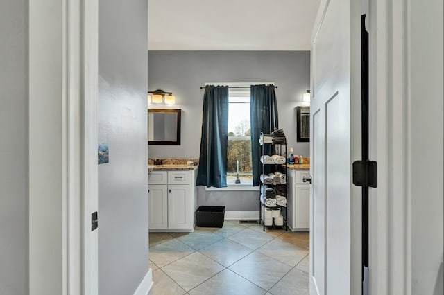 bathroom featuring vanity, a tub, and tile patterned floors