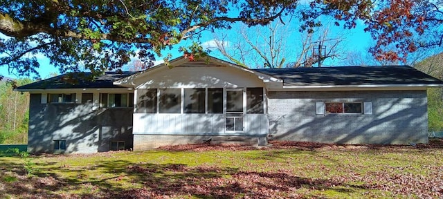 exterior space with a sunroom and a yard