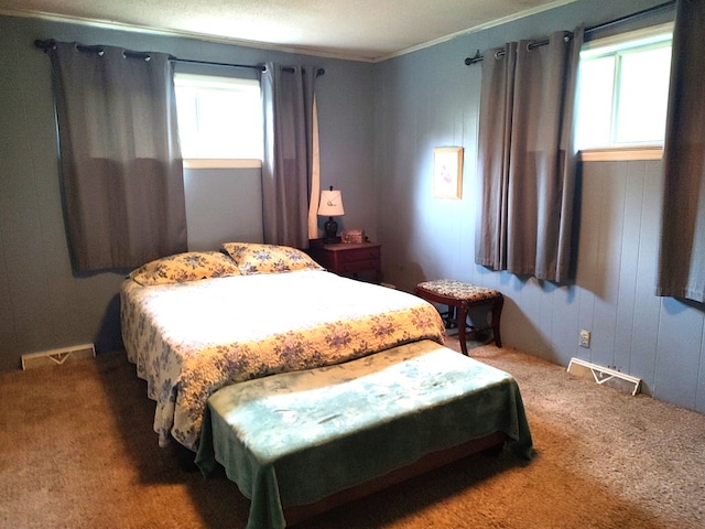 carpeted bedroom with multiple windows and crown molding