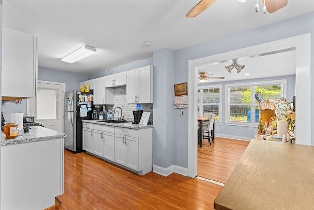 1369 Lida St, Dalton, GA 30721 - kitchen featuring a ceiling fan, freestanding refrigerator, light wood-type flooring, and white cabinets