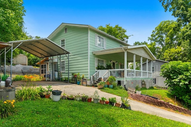 1369 Lida St, Dalton, GA 30721 - back of house with a porch, a detached carport, a yard, and driveway