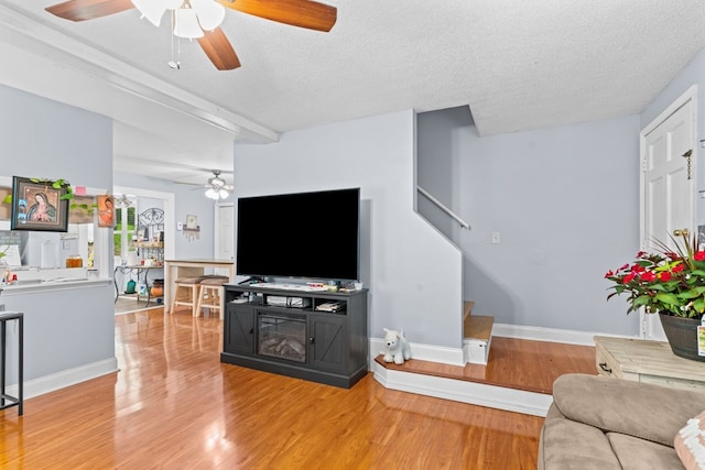 1369 Lida St, Dalton, GA 30721 - living room with ceiling fan, light wood-style flooring, stairs, and a textured ceiling