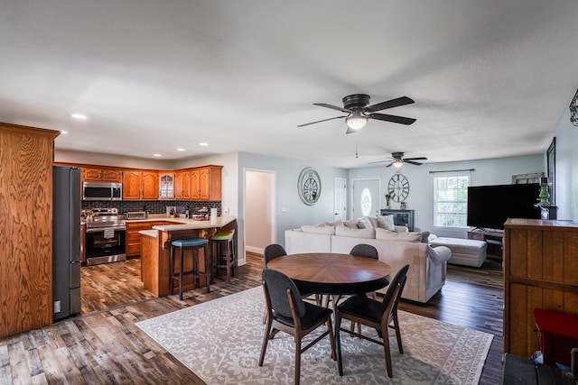 2163 Red Leaf Ln, Soddy Daisy, TN 37379 - dining room featuring ceiling fan, dark wood-style flooring, and recessed lighting