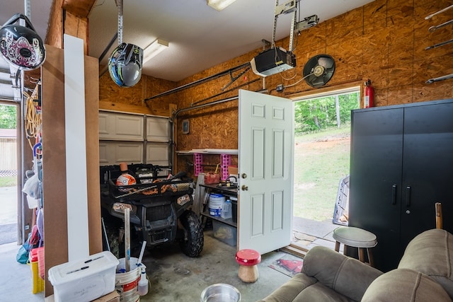 2163 Red Leaf Ln, Soddy Daisy, TN 37379 - garage with a garage door opener and wooden walls