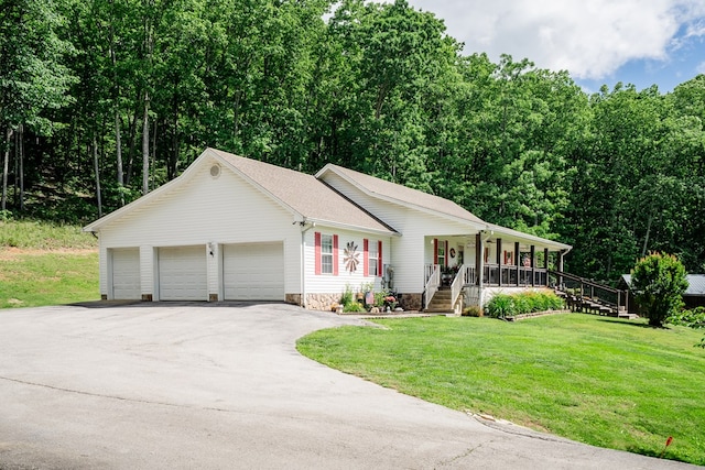2163 Red Leaf Ln, Soddy Daisy, TN 37379 - view of front of house with a porch, driveway, an attached garage, and a front yard