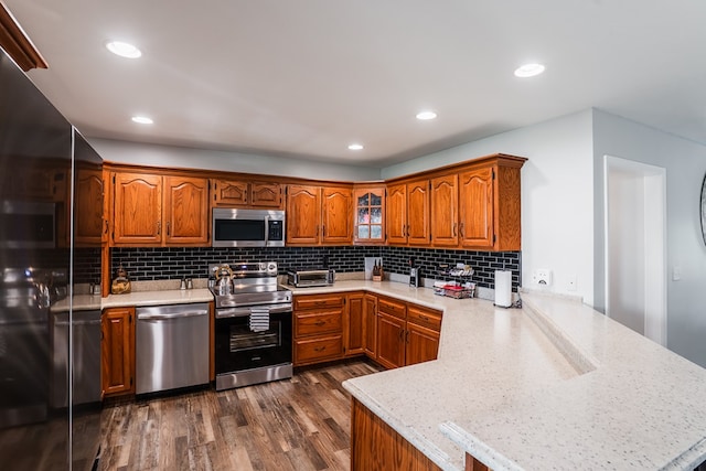 2163 Red Leaf Ln, Soddy Daisy, TN 37379 - kitchen featuring appliances with stainless steel finishes, a peninsula, dark wood-type flooring, light countertops, and recessed lighting