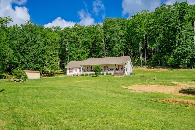 2163 Red Leaf Ln, Soddy Daisy, TN 37379 - view of front of house with a porch, a front yard, a forest view, and a shed