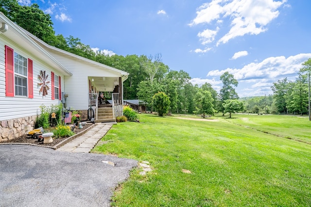 2163 Red Leaf Ln, Soddy Daisy, TN 37379 - view of grassy yard with covered porch and view of wooded area
