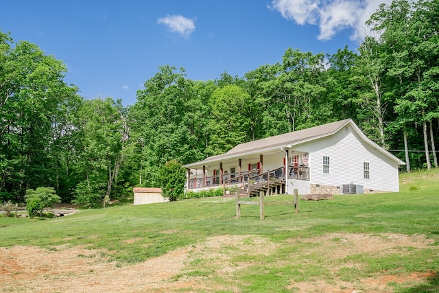 2163 Red Leaf Ln, Soddy Daisy, TN 37379 - view of front of home with covered porch, a front yard, a storage unit, and a wooded view