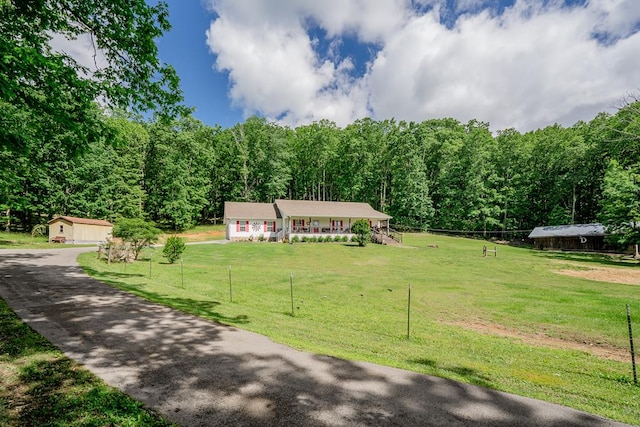 2163 Red Leaf Ln, Soddy Daisy, TN 37379 - view of front of home featuring a view of trees, driveway, an outbuilding, and a porch