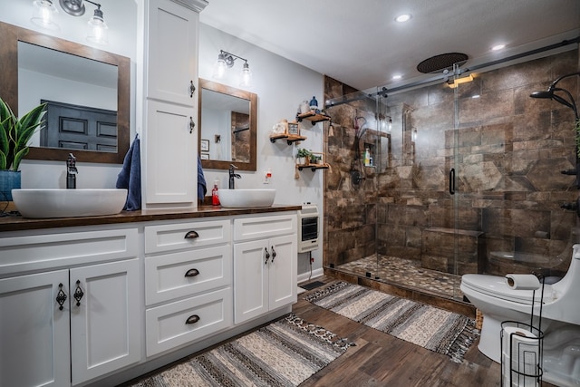 2163 Red Leaf Ln, Soddy Daisy, TN 37379 - full bathroom with wood finished floors, a shower stall, heating unit, double vanity, and recessed lighting