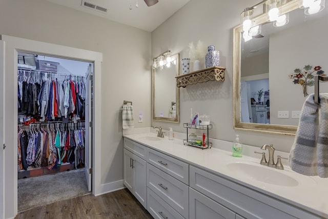 bathroom featuring wood-type flooring, vanity, and ceiling fan