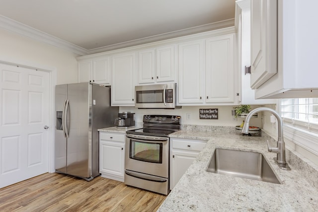 1951 Oxford Ct Unit 10, Dalton, GA 30720 - kitchen with stainless steel appliances, a sink, crown molding, white cabinets, and light wood-style floors