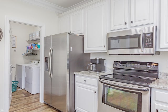 1951 Oxford Ct Unit 10, Dalton, GA 30720 - kitchen featuring appliances with stainless steel finishes, washing machine and dryer, ornamental molding, white cabinetry, and light wood finished floors