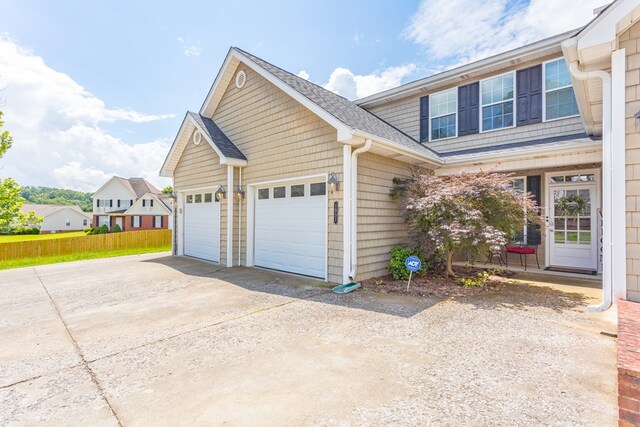 1951 Oxford Ct Unit 10, Dalton, GA 30720 - view of side of property featuring a garage, concrete driveway, and a shingled roof