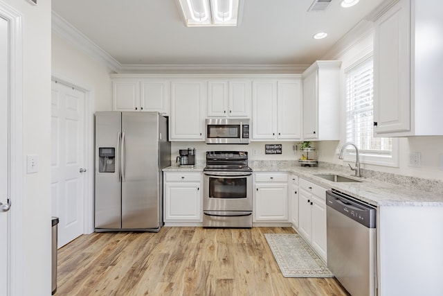 1951 Oxford Ct Unit 10, Dalton, GA 30720 - kitchen with stainless steel appliances, a sink, white cabinetry, ornamental molding, and light wood-style floors