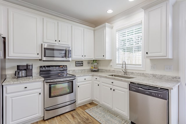 1951 Oxford Ct Unit 10, Dalton, GA 30720 - kitchen featuring stainless steel appliances, a sink, white cabinetry, and light wood-style floors