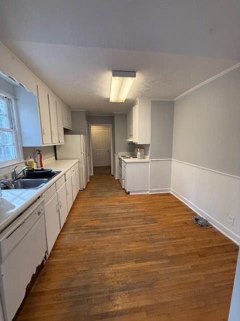 kitchen featuring white appliances, sink, light hardwood / wood-style flooring, and white cabinets