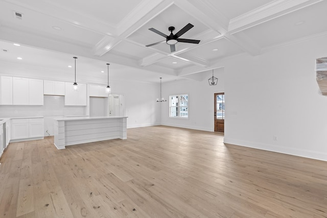 unfurnished living room featuring coffered ceiling, beam ceiling, light hardwood / wood-style floors, and crown molding