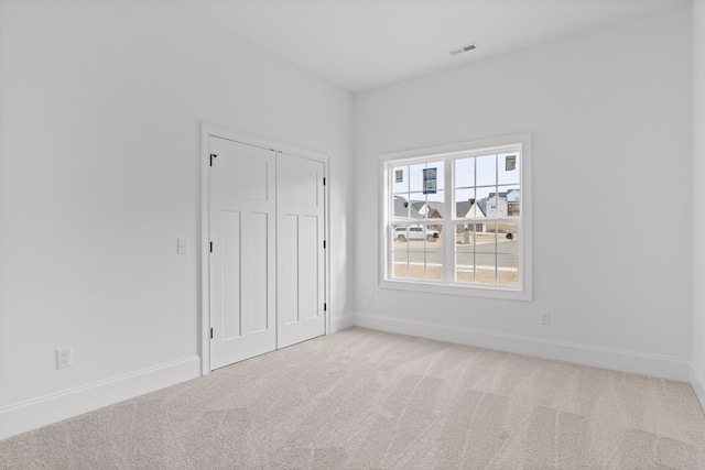 empty room with light colored carpet