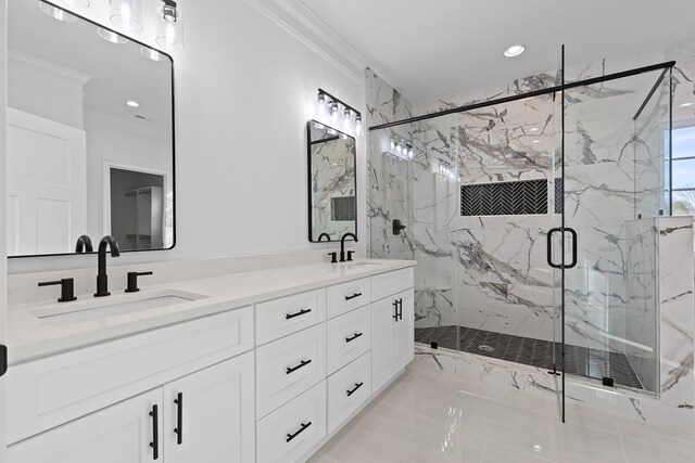 bathroom featuring vanity, ornamental molding, and a shower with door