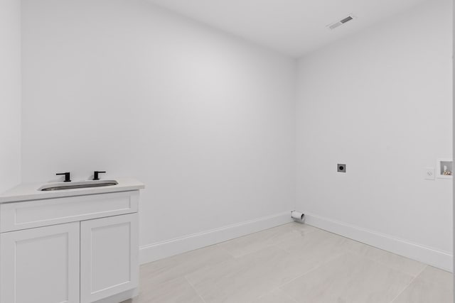 clothes washing area with cabinets, washer hookup, hookup for an electric dryer, and sink