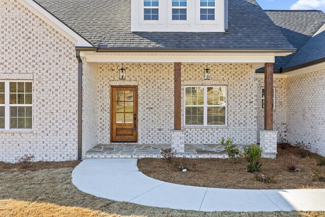 entryway with plenty of natural light, ornamental molding, and light wood-type flooring