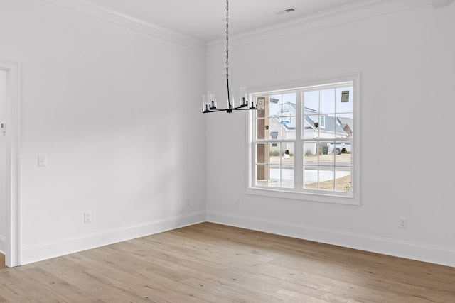 unfurnished dining area featuring an inviting chandelier, ornamental molding, and light hardwood / wood-style flooring