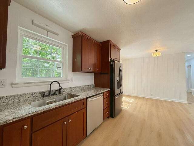 42 Travis Rd, Rossville, GA 30741 - kitchen with appliances with stainless steel finishes, a sink, light wood finished floors, light stone countertops, and brown cabinets