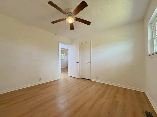 42 Travis Rd, Rossville, GA 30741 - empty room with plenty of natural light, light wood-style floors, baseboards, and a ceiling fan