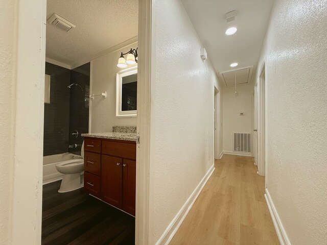 42 Travis Rd, Rossville, GA 30741 - corridor featuring attic access, a textured wall, light wood-style floors, ornamental molding, and baseboards