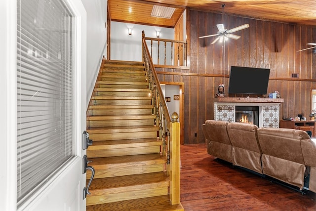 5120 Cleveland Hwy, Cohutta, GA 30710 - stairway featuring wood ceiling, wooden walls, a fireplace, ceiling fan, and wood finished floors