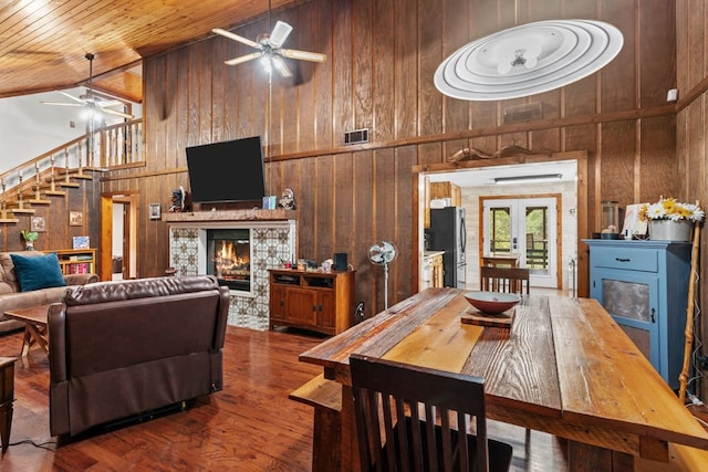 5120 Cleveland Hwy, Cohutta, GA 30710 - dining space featuring ceiling fan, a glass covered fireplace, high vaulted ceiling, wooden walls, and wooden ceiling