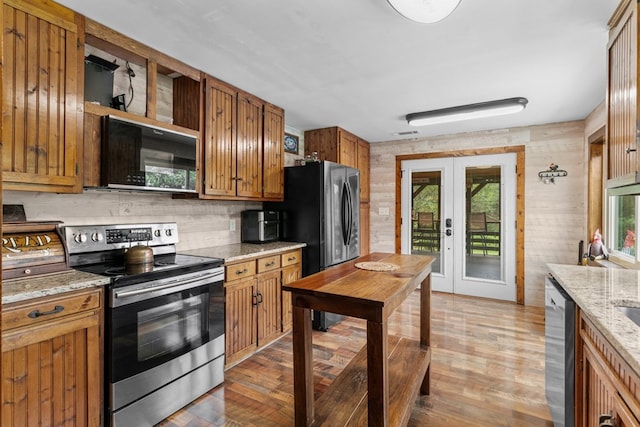 5120 Cleveland Hwy, Cohutta, GA 30710 - kitchen featuring appliances with stainless steel finishes, brown cabinetry, tasteful backsplash, open shelves, and french doors