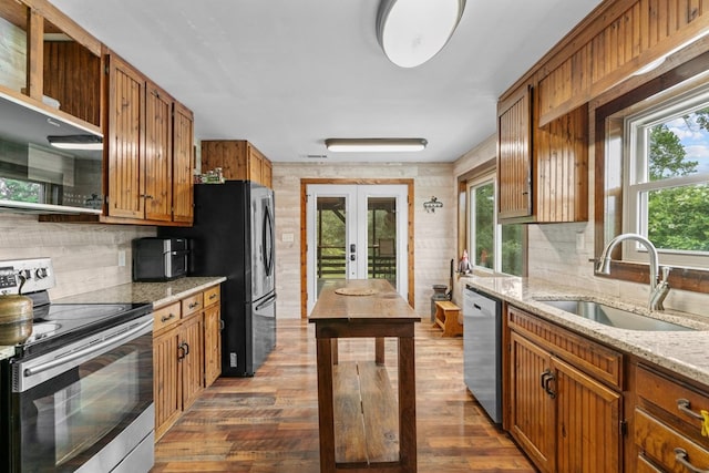 5120 Cleveland Hwy, Cohutta, GA 30710 - kitchen featuring stainless steel appliances, decorative backsplash, and brown cabinets