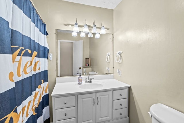 bathroom with vanity, toilet, and a shower with shower curtain