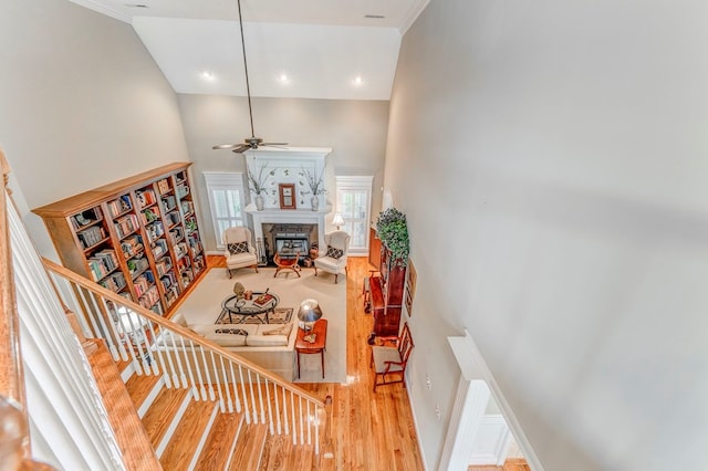 1909 Keystone Way, Dalton, GA 30720 - staircase featuring a high ceiling, wood finished floors, ceiling fan, a glass covered fireplace, and crown molding