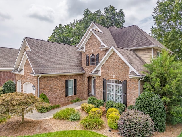 1909 Keystone Way, Dalton, GA 30720 - traditional-style home featuring roof with shingles, a garage, and brick siding