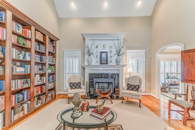 1909 Keystone Way, Dalton, GA 30720 - sitting room featuring wood finished floors, a tile fireplace, a towering ceiling, and arched walkways