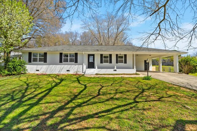 ranch-style house featuring a carport and a front yard