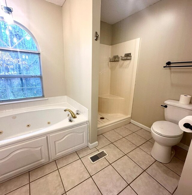 washroom featuring gas dryer hookup, cabinets, hookup for an electric dryer, and light tile patterned floors